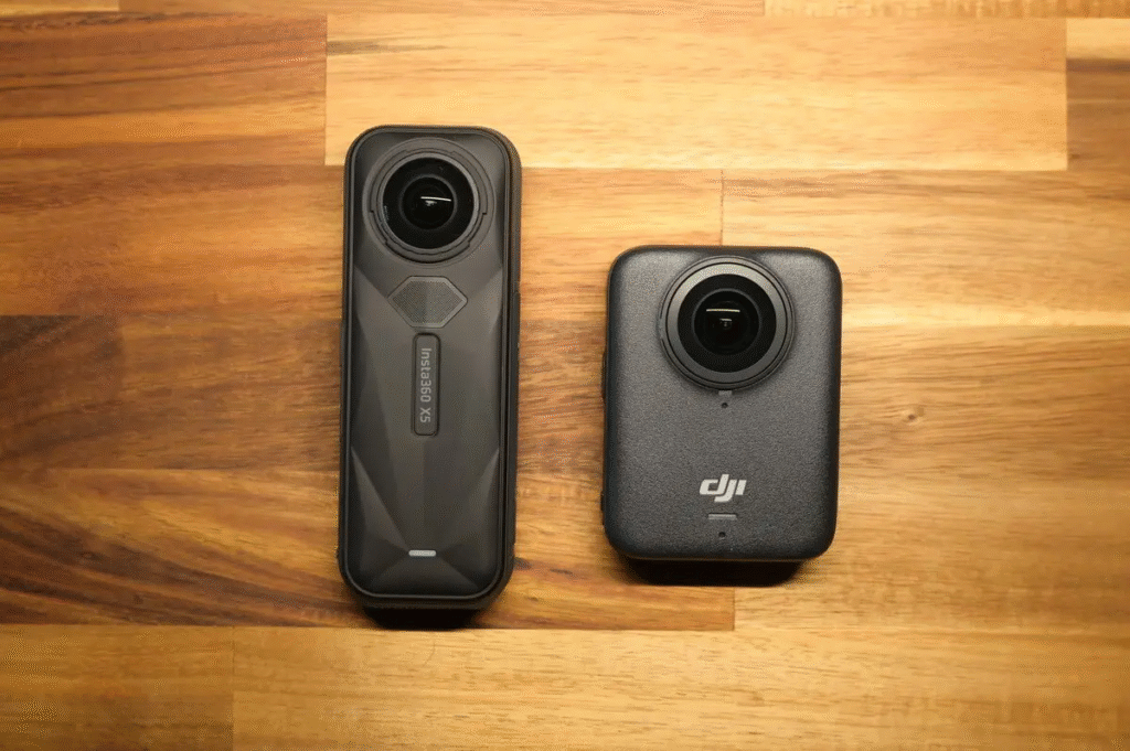 a pair of cameras on a wood surface